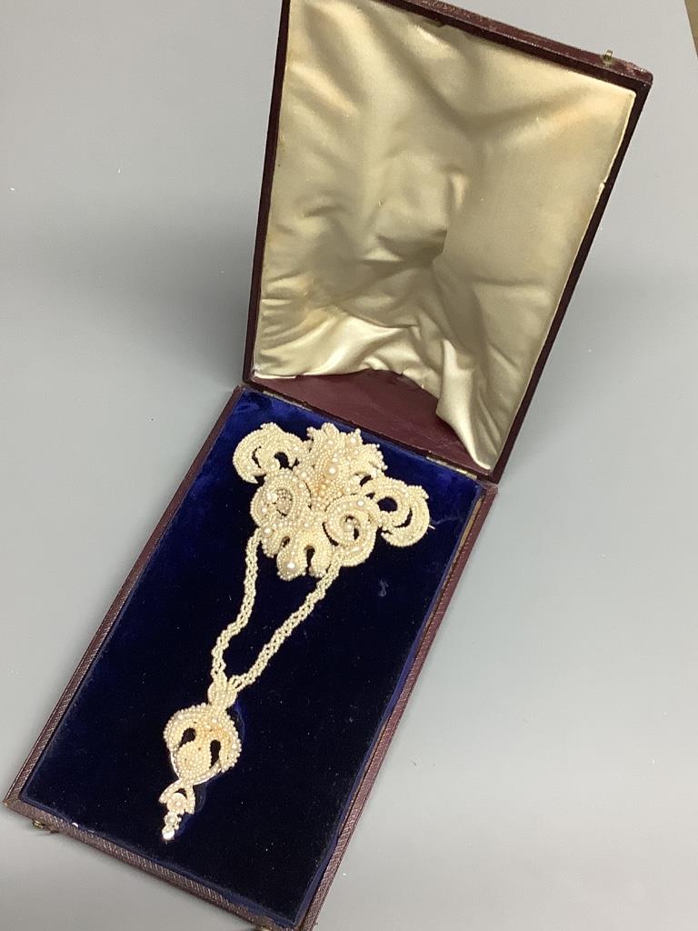 A 19th century seed pearl encrusted drop brooch in fitted box, 13.9 cm.